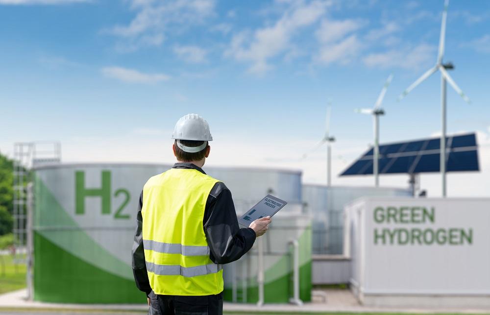 Engineer,With,Tablet,Computer,On,A,Background,Of,Green,Hydrogen