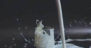 white candle in clear glass holder