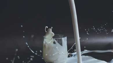 white candle in clear glass holder