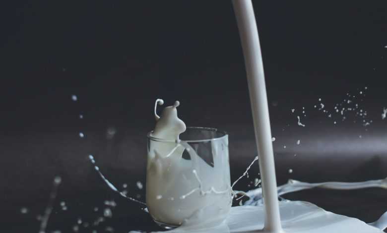 white candle in clear glass holder