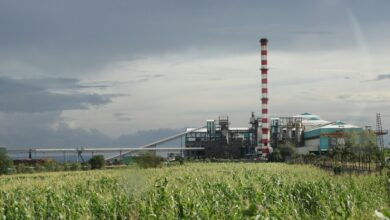 a factory with a large pipe sticking out of it's side