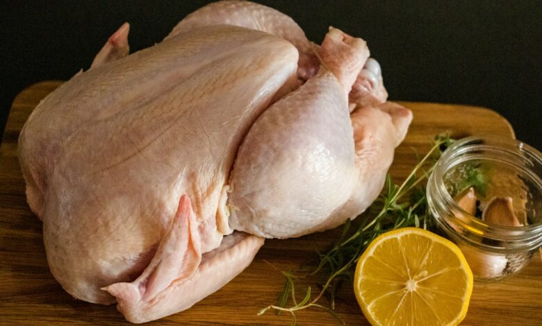 raw chicken meat on brown wooden chopping board