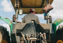 man riding tractor