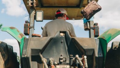 man riding tractor