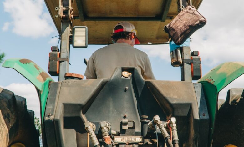 man riding tractor