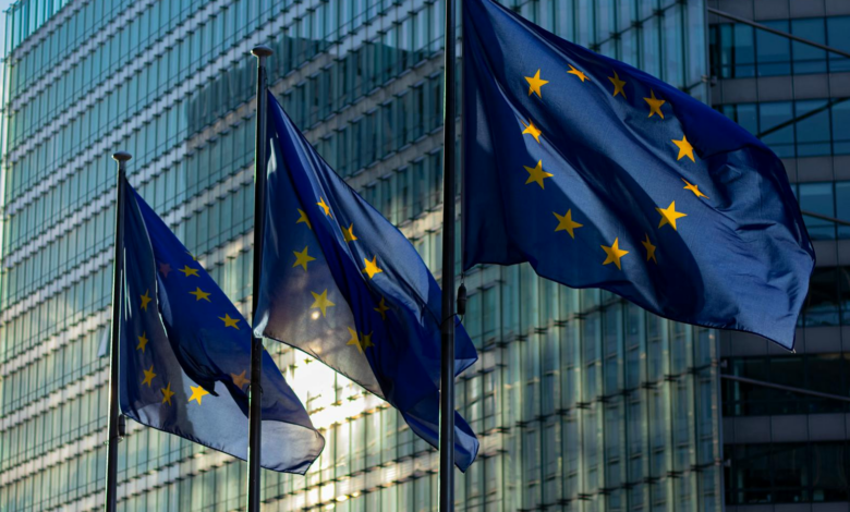 EU flags waving in front of the European Commission building in Brussels, Belgium.