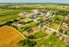 Aerial shot of Hercegovac, Croatia, showing industrial and agricultural landscape.