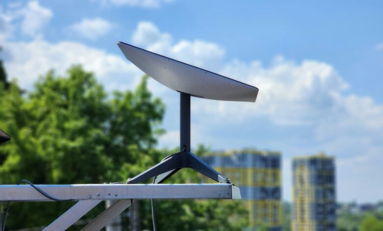 a white surfboard sitting on top of a metal pole