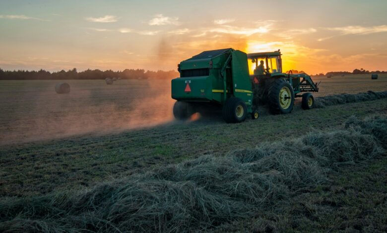 green farm heavy equipment on green field