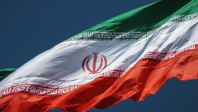 the flag of the country of iraq flying in the sky