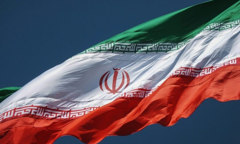 the flag of the country of iraq flying in the sky