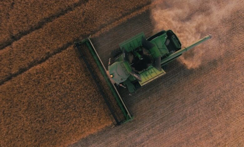 green farming equipment on brown field