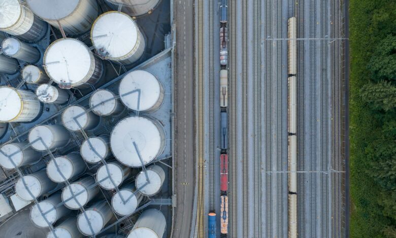 Overhead view of industrial silos and a train on tracks.