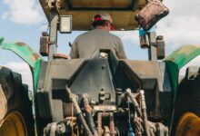 man riding tractor