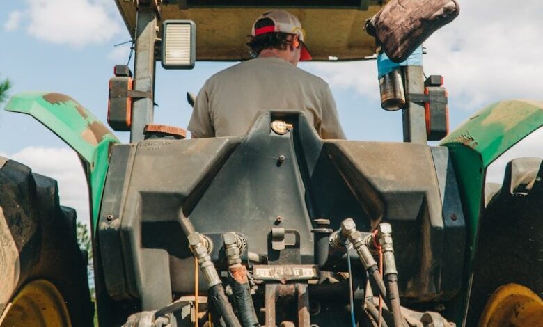 man riding tractor