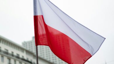 The polish flag waves in the breeze.