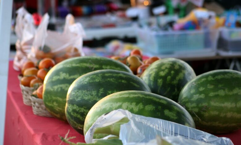 a bunch of watermelons sitting on a table