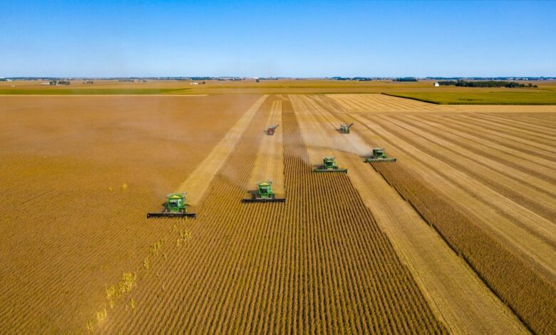 green truck on brown field under blue sky during daytime