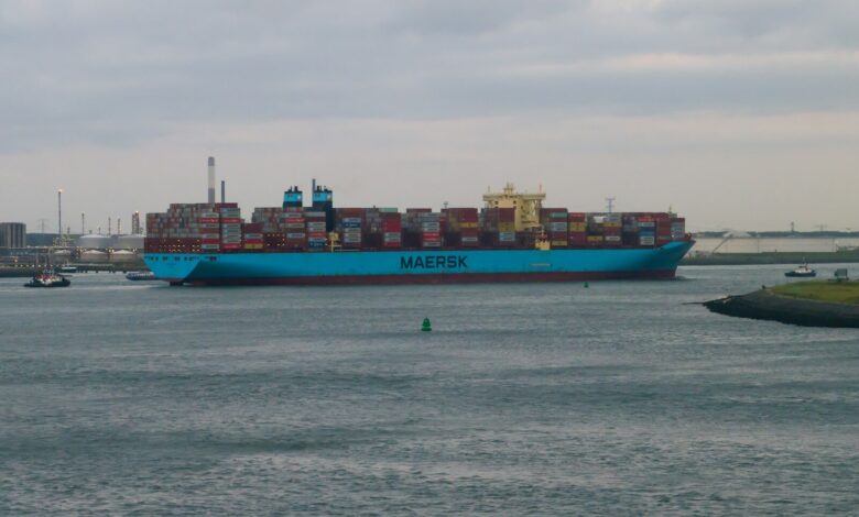 a large blue cargo ship in the middle of a body of water