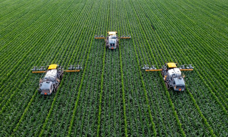 yellow and black heavy equipment on green field during daytime